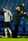 Tottenham's Gareth Bale, left walks past Tottenham's manager Jose Mourinho after being substituted during an English Premier League soccer match between Brighton and Tottenham Hotspur at the Amex stadium in Brighton, England, Sunday Jan. 31, 2021. (Andrew Boyers//Pool via AP)