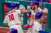 Philadelphia Phillies J.T. Realmuto (10) is congratulated by Bryce Harper after hitting a three run homer during the fifth inning of a baseball game against the New York Mets, Wednesday, April 7, 2021, in Philadelphia. (AP Photo/Laurence Kesterson)