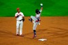 Atlanta Braves' Ronald Acuna Jr., right, playfully leaps at Philadelphia Phillies second baseman Jean Segura after hitting a double off pitcher Zack Wheeler during the sixth inning of a baseball game, Friday, Aug. 28, 2020, in Philadelphia. (AP Photo/Matt Slocum)