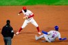 Philadelphia Phillies shortstop Didi Gregorius, center, forces out New York Mets' Jeff McNeil at second on a fielder's choice by Andres Gimenez during the fifth inning of a baseball game, Wednesday, Sept. 16, 2020, in Philadelphia. Gimenez was safe at first. (AP Photo/Matt Slocum)
