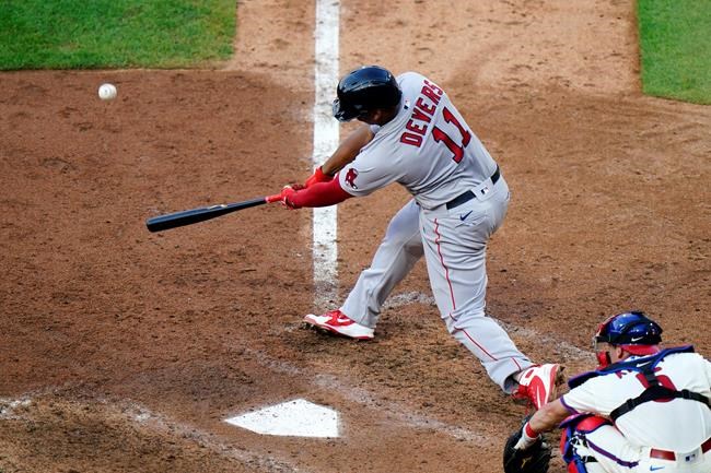Boston Red Sox's Rafael Devers hits an RBI-double off Philadelphia Phillies pitcher Tommy Hunter during the sixth inning of the first baseball game in a doubleheader, Tuesday, Sept. 8, 2020, in Philadelphia. (AP Photo/Matt Slocum)