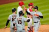 San Francisco Giants' Wilmer Flores, right, celebrates with Austin Slater, center, and Buster Posey, left, after hitting a three-run home run off Philadelphia Phillies pitcher Connor Brogdon during the eighth inning of a baseball game, Tuesday, April 20, 2021, in Philadelphia. (AP Photo/Matt Slocum)