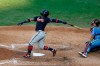 Atlanta Braves' Ronald Acuna Jr. follows through after hitting a home run off Philadelphia Phillies pitcher Spencer Howard during the fifth inning of the second baseball game in a doubleheader, Sunday, Aug. 9, 2020, in Philadelphia. (AP Photo/Matt Slocum)