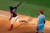 Atlanta Braves' Ronald Acuna Jr., left, reacts past Philadelphia Phillies first baseman Rhys Hoskins after hitting a two-run home run off relief pitcher Trevor Kelley during the sixth inning of the second baseball game in a doubleheader, Sunday, Aug. 9, 2020, in Philadelphia. (AP Photo/Matt Slocum)