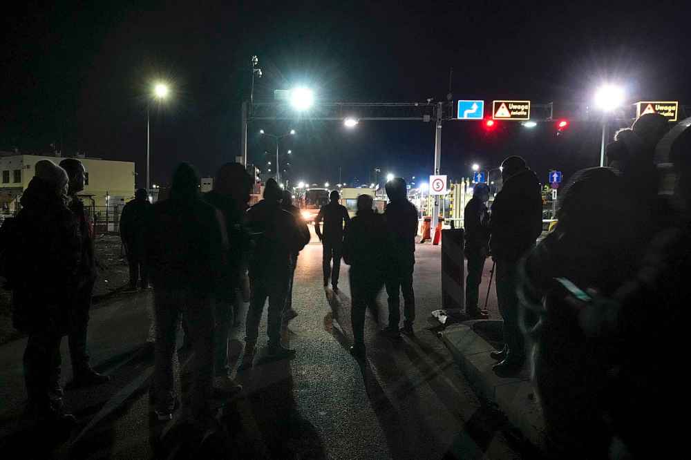 CP
People wait for members of their family fleeing the conflict from neighboring Ukraine at the border crossing in Medyka, southeastern Poland, on Friday, Feb. 25, 2022. U.N. officials said that 100,000 people were believed to have left their homes and estimated up to 4 million could flee if the fighting escalates. (AP Photo/Czarek Sokolowski)
