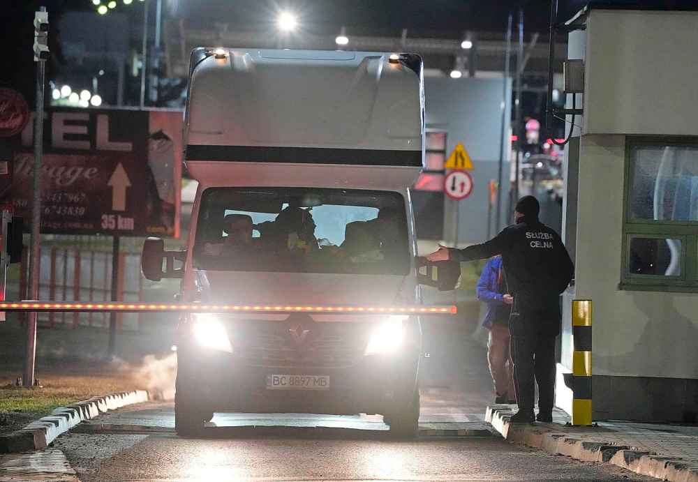 CP
An officer of Poland's Border Guard directs the traffic of cars coming in from neighboring Ukraine at the border crossing in Medyka, Poland, on Thursday, Feb. 24, 2022. Russia launched a wide-ranging attack on Ukraine on Thursday, hitting cities and bases with airstrikes or shelling, as civilians piled into trains and cars to flee. (AP Photo/Czarek Sokolowski)