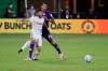 Los Angeles FC forward Diego Rossi (9) battles for the ball with Orlando City defender Antonio Carlos (25) during the second half of an MLS soccer match, Friday, July 31, 2020, in Orlando, Fla. (AP Photo/John Raoux)