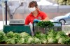 A worker wears a mask while selling produce at a farmers market amid the COVID-19 pandemic Wednesday, April 15, 2020, in Ventura, Calif. Canada's farmers markets, traditionally reliant on bustling crowds paying cash for locally produced food, seem particularly ill-suited to the age of physical distancing.THE CANADIAN PRESS/AP Photo/Marcio Jose Sanchez