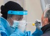 A health-care worker prepares to swab a man at a walk-in COVID-19 test clinic in Montreal North, Sunday, May 10, 2020, as the COVID-19 pandemic continues in Canada and around the world. THE CANADIAN PRESS/Graham Hughes