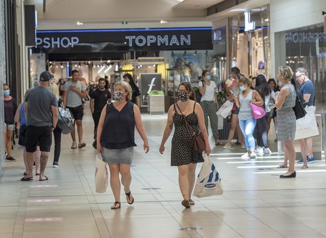 Shoppers walk through Carrefour Laval shopping centre as malls across Quebec reopened amid the COVID-19 pandemic, Friday, June 19, 2020 in Laval, Que. Statistics Canada says the economy grew by 4.5 per cent in May as businesses began to reopen after severe lockdowns of March and April. THE CANADIAN PRESS/Ryan Remiorz