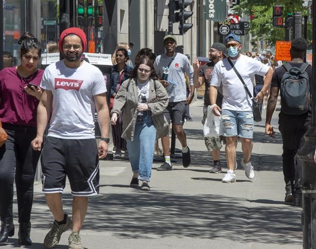 Pedestrians walk on Ste. Catherine street, Thursday, June 18, 2020 in Montreal. A group of 239 scientists and physicians urging the World Health Organization to recognize the potential for airborne transmission of the novel coronavirus have sparked debate over how COVID-19 is spreading.But some Canadian infectious disease experts say not to get hung up on the term