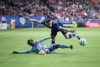 Sporting Kansas City's Gerso Fernandes, left, and Vancouver Whitecaps' Jake Nerwinski fall to the ground while vying for the ball during the second half of an MLS soccer game in Vancouver, B.C., Saturday, Feb. 29, 2020. After a heartbreaking 4-3 loss to the San Jose Earthquakes that featured a 98th-minute winner, the young Whitecaps find themselves matched against the MLS champion Seattle Sounders on Sunday at the MLS is Back Tournament in Florida. The Sounders are desperate for points, having secured just one in their first two matches. THE CANADIAN PRESS/Darryl Dyck