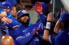 Toronto Blue Jays' Teoscar Hernandez is congratulated by teammates after his three-run home run, breaking a 2-2 tie, in 10th inning of a baseball game against the Boston Red Sox, Thursday Sept. 3, 2020, in Boston. Hernandez is back in the Toronto Blue Jays lineup after missing almost two weeks due to oblique strain. THE CANADIAN PRESS/AP/Charles Krupa
