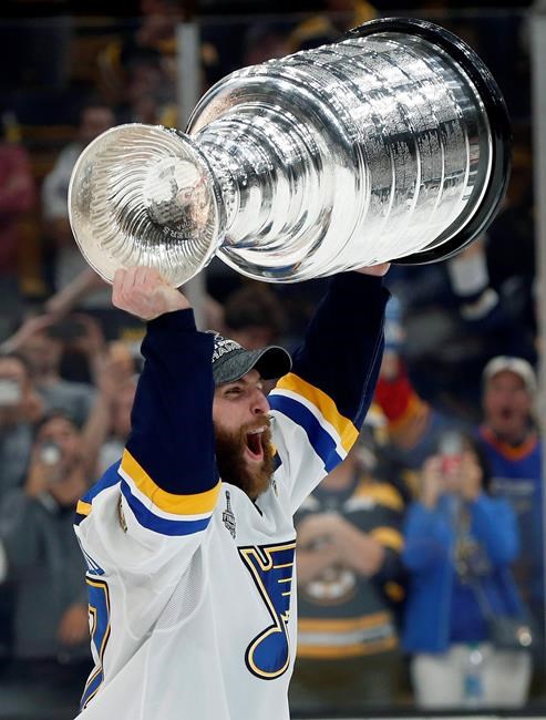 St. Louis Blues' Alex Pietrangelo hoists the Stanley Cup after the Blues defeated the Boston Bruins in Game 7 of the NHL Stanley Cup Final, Wednesday, June 12, 2019, in Boston. It looks like hockey fans will be able to cheer on their favourite NHL team this summer but Canadians have issued a collective shrug about whether the Stanley Cup is hoisted on their home ice. THE CANADIAN PRESS/AP/Michael Dwyer