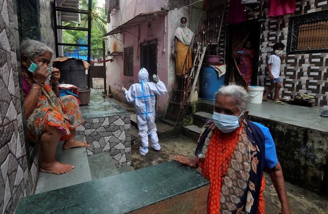 A health worker calls out to people to come out for screening for COVID-19 symptoms in Dharavi, one of Asia's biggest slums, in Mumbai, India, Tuesday, Aug. 11, 2020. India has the third-highest coronavirus caseload in the world after the United States and Brazil. (AP Photo/Rafiq Maqbool)