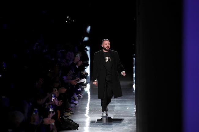 FILE -- In this Jan. 17, 2020 file photo, designer Kim Jones accepts applause after the Dior Homme Mens Fall/Winter 2020-2021 fashion collection presented in Paris. Rome fashion house Fendi announced Wednesday, Sept. 9, 2020 that Kim Jones is taking over from the late Karl Lagerfeld as creative director of haute couture, ready-to-wear and fur collections. Jones will take on the Fendi duties while staying on as artistic director of Dior Homme. (AP Photo/Francois Mori)