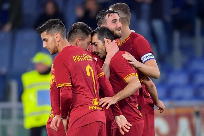 Roma's Henrikh Mkhitaryan, third from left, celebrates with teammates after scoring his side's second goal during the Italian Serie A soccer match between Roma and Lecce at the Olympic stadium in Rome, Sunday, Feb. 23, 2020. (Fabio Rossi/LaPresse via AP)