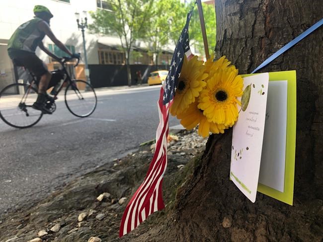 A small memorial to Portland, Oregon fatal shooting victim Aaron J. Danielson, 39, of Portland is shown on Monday, Aug. 31, 2020, at the site where he was killed on Saturday, Aug. 29, 2020, as supporters of President Donald Trump and Black Lives Matter protesters clashed. Danielson was a supporter of the right-wing Patriot Prayer group but few details have emerged about what led up to the shooting. No suspects have been arrested. (AP Photo/Gillian Flaccus)