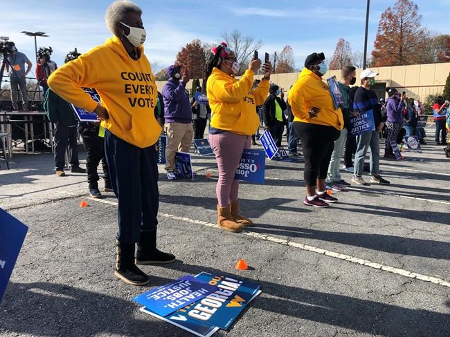 Union members attend a rally, Friday, Dec. 11, 2020, in Atlanta, for election canvassers in Georgia's twin Senate races. The early in-person voting period beginning Monday, Dec. 14, 2020, and lasting as late as Dec. 31 could determine the outcomes of races between Republican U.S. Sens. David Perdue and Kelly Loeffler and Democratic challengers Jon Ossoff and Raphael Warnock that will decide control of the U.S. Senate. (AP Photo/Jeff Amy)