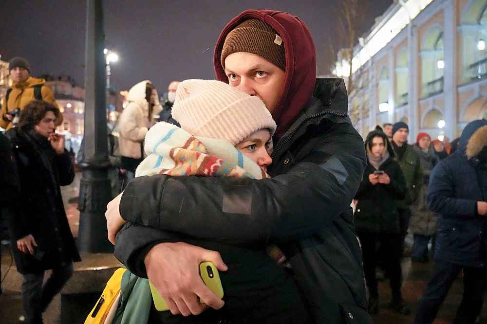 CP
A couple stand and embrace during a gathering in St. Petersburg, Russia, Friday, Feb. 25, 2022. Shocked Russians turned out by the thousands Thursday to decry their country's invasion of Ukraine as emotional calls for protests grew on social media. Some 1,745 people in 54 Russian cities were detained, at least 957 of them in Moscow. (AP Photo/Dmitri Lovetsky)