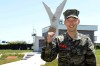 In this undated photo provided by South Korea Marine Corps' Facebook on Friday, May 8, 2020, Tottenham Hotspur forward Son Heung-min poses at a Marine Corps boot camp in Seogwipo on Jeju Island, South Korea. Son finished his three-week military training in South Korea on Friday and was right near the top of the class.(South Korea Marine Corps' Facebook via AP).
