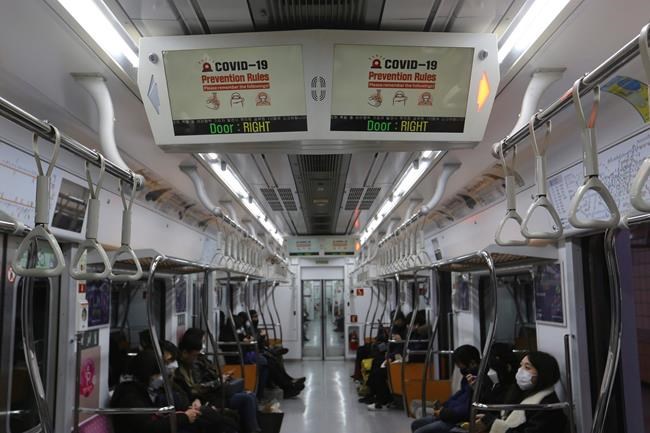 Electric screens about precautions against the illness COVID-19 are seen in a subway train in Seoul, South Korea, Sunday, Feb. 23, 2020. South Korea's president said Sunday that he was putting his country on its highest alert for infectious diseases and ordered officials to take