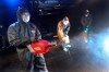 Workers wearing protective gears spray disinfectant as a precaution against a new coronavirus at a theater in Seoul, South Korea, Thursday, Feb. 6, 2020. Ten more people were sickened with a new virus aboard one of two quarantined cruise ships with some 5,400 passengers and crew aboard, health officials in Japan said Thursday, as China reported 73 more deaths and the World Health Organization appealed for more funds to help countries battle the spread of the disease. (AP Photo/Ahn Young-joon)