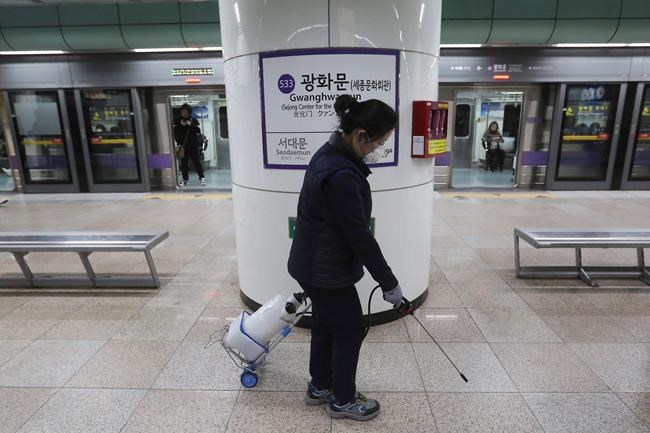 An employee disinfects the platform in hopes to prevent transmission of the coronavirus at a subway station in Seoul, South Korea, Tuesday, Jan. 28, 2020. Deaths from a new viral disease that is causing mounting global concern rose by 25 to at least 106 in China on Tuesday as the United States and other governments prepared to fly their citizens out of the locked-down city at center of the outbreak.(AP Photo/Ahn Young-joon)