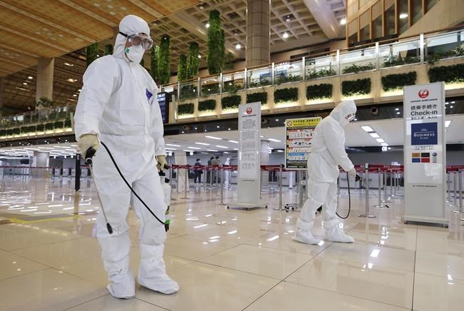 Workers wearing protective suits spray disinfectant as a precaution against the coronavirus at the Gimpo Airport in Seoul, South Korea, Tuesday, March 10, 2020. For most people, the new coronavirus causes only mild or moderate symptoms, such as fever and cough. For some, especially older adults and people with existing health problems, it can cause more severe illness, including pneumonia. . (Lee Ji-eun/Yonhap via AP)