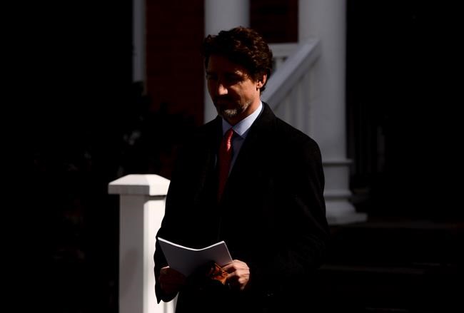 Prime Minister Justin Trudeau arrives to address Canadians on the COVID-19 situation from Rideau Cottage in Ottawa on Wednesday, March 25, 2020. THE CANADIAN PRESS/Sean Kilpatrick