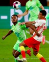 Wolfsburg's Bote Baku, left, and Leipzig's Tyler Adams, right, challenge for the ball during the German soccer cup, DFB Pokal, quarter final match between RB Leipzig and VfL Wolfsburg in Leipzig, Germany, Wednesday, March 3, 2021. (AP Photo/Michael Sohn)