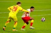 Cologne's Jan Thielmann, left, and Leipzig's Tyler Adams, right, challenge for the ball during the German Bundesliga soccer match between RB Leipzig and 1. FC Cologne in Leipzig, Germany, Saturday, Dec. 19, 2020. (AP Photo/Michael Sohn)