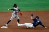 Atlanta Braves second baseman Ozzie Albies forces Tampa Bay Rays' Brandon Lowe (8) at second base and relays the throw to first base in time to turn a double play on Rays' Jose Martinez during the first inning of a baseball game Monday, July 27, 2020, in St. Petersburg, Fla. (AP Photo/Chris O'Meara)