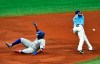 Toronto Blue Jays' Vladimir Guerrero Jr., left, slide past Tampa Bay Rays' Yandy Diaz, right, into third base with a triple during the fourth inning of a baseball game Sunday, Aug. 23, 2020, in St. Petersburg, Fla. (AP Photo/Steve Nesius)