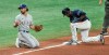 Texas Rangers' Charlie Culberson, left, looks to the Texas dugout after Tampa Bay Rays' Manuel Margot, right, stole third base during the fourth inning of a baseball game Thursday, April 15, 2021, in St. Petersburg, Fla. (AP Photo/Steve Nesius)
