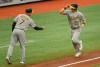 Oakland Athletics third base coach Mark Kotsay (7) congratulates Matt Chapman (26) after his solo home run off Tampa Bay Rays' Shane McClanahan during the fourth inning of a baseball game Thursday, April 29, 2021, in St. Petersburg, Fla. (AP Photo/Steve Nesius)