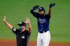 Tampa Bay Rays' Jose Martinez celebrates his two-run double off Toronto Blue Jays starting pitcher Ryan Borucki during the sixth inning of a baseball game Friday, Aug. 21, 2020, in St. Petersburg, Fla. Umpire David Arrieta calls time. (AP Photo/Chris O'Meara)