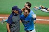 Tampa Bay Rays' Kevin Kiermaier, right, hugs manager Kevin Cash after Kiermaier hit a two-run walkoff double off Toronto Blue Jays relief pitcher Shun Yamaguchi during the 10th inning of a baseball game Sunday, July 26, 2020, in St. Petersburg, Fla. The Rays won the game 6-5. (AP Photo/Chris O'Meara)