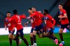 Lille's Burak Yilmaz, center, reacts with teammates after scoring during their French League One soccer match between Lille and Nice in Villeneuve d'Ascq, northern France, Saturday May 1, 2021. (AP Photo/Michel Spingler)