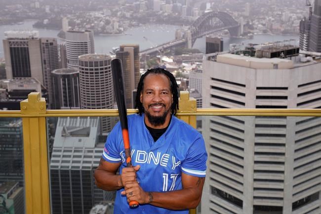 Major League Baseball all-star Manny Ramirez poses for a photograph overlooking Sydney, Wednesday, Dec. 2, 2020. Ramirez, who was the World Series MVP when the Red Sox broke their 86-year title drought in 2004, is scheduled to begin the season on Thursday, Dec. 17, 2020, for the Sydney Blue Sox in the Australian Baseball League. (Dan Himbrechts/AAP Image via AP)
