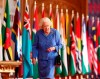 Britain's Queen Elizabeth II walks past Commonwealth flags in St George's Hall at Windsor Castle, England to mark Commonwealth Day in this image that was issued on Saturday March 6, 2021. The timing couldn’t be worse for the Queen's grandson Harry and his wife Meghan. The Duke and Duchess of Sussex will finally get the chance to tell the story behind their departure from royal duties directly to the public on Sunday, when their two-hour interview with Oprah Winfrey is broadcast. (Steve Parsons/Pool via AP)