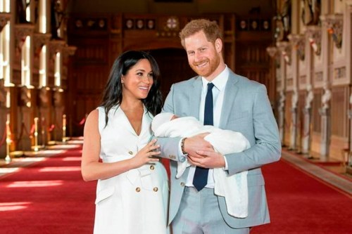 FILE - In this Wednesday May 8, 2019 file photo Britain's Prince Harry and Meghan, Duchess of Sussex, pose during a photocall with their newborn son Archie, in St George's Hall at Windsor Castle, Windsor, south England. The Duchess of Sussex has revealed that she had a miscarriage in July. Meghan described the experience in an opinion piece in the New York Times on Wednesday. She wrote: 