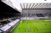 Players warm up before the English Premier League soccer match between Newcastle and Liverpool at St. James' Park in Newcastle, England, Sunday, July 26, 2020. (Laurence Griffiths, Pool via AP)