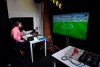 Soccer commentator Dan O'Hagan commentates on the German Bundesliga soccer match between Freiburg and Werder Bremen remotely from a studio in Camden Town, London, Saturday May 23, 2020. The Bundesliga is the only soccer major league to have resumed since the start of the coronavirus lockdown and with increased global demand matches are also being provided to customers with a commentary in English. (AP Photo/Alberto Pezzali)