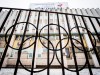 FILE - In this Dec. 6, 2017, file photo, the building of the Russian Olympic Committee is seen through a gate decorated with the Olympic rings, in Moscow, Russia. The ruling on whether Russia can keep its name and flag for the Olympics will be announced on Thursday Dec. 17, 2020. The Court of Arbitration for Sport said Wednesday that three of its arbitrators held a four-day hearing last month in the dispute between the World Anti-Doping Agency and its Russian affiliate, known as RUSADA. (AP Photo/Alexander Zemlianichenko, File)