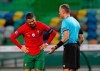 FILE - In this Wednesday, Oct. 7, 2020 file photo Portugal's Cristiano Ronaldo, left, reacts as he speaks with referee Paolo Valeri during the international friendly soccer match between Portugal and Spain at the Jose Alvalade stadium in Lisbon. The Portuguese soccer federation says Cristiano Ronaldo has tested positive for the coronavirus. The federation says Ronaldo is doing well and has no symptoms. He has been dropped from the country's Nations League match against Sweden on Wednesday. (AP Photo/Armando Franca, File)