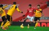 Manchester United's Marcus Rashford, in red, runs with the ball during the English Premier League soccer match between Manchester Utd and Wolverhampton Wanderers at Old Trafford stadium in Manchester, England, Tuesday Dec. 29, 2020. (Martin Rickett, Pool via AP)