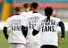 Leeds United players wear t-shirts with the logo 'Football Is For The Fans' as they warm-up ahead of ahead of the English Premier League soccer match between Leeds United and Liverpool at the Elland Road stadium in Leeds, England, Monday, April 19, 2021. (Clive Brunskill/Pool via AP)