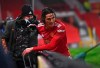Manchester United's Edinson Cavani gets up after running into the advertising boards during the English Premier League soccer match between Manchester Utd and Wolverhampton Wanderers at Old Trafford stadium in Manchester, England, Tuesday,Dec. 29, 2020. (Laurence Griffiths, Pool via AP)