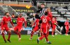 Newcastle's Ciaran Clark, center, has a header at goal during the English Premier League soccer match between Newcastle United and Liverpool at St James' Park stadium in Newcastle, England, Wednesday, Dec. 30, 2020. (Stu Forster/ Pool via AP)